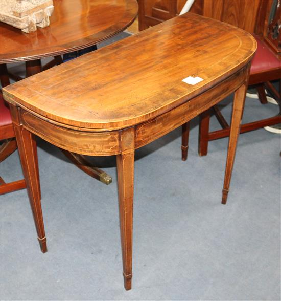 A George III cross and band-inlaid mahogany D-shaped card table, W.92cm